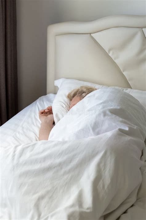 Sleeping Mature Man On A Bed With White Linen In His Bedroom Comfortable Rest And Relaxation