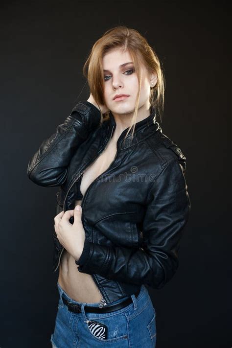 Studio Portrait Of Blonde Woman With Leather Biker Jacket Look Stock Image Image Of Denim