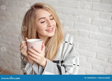 Young Happy Girl Wrapped In A Warm Blanket Looks Happy Holding Cup Of