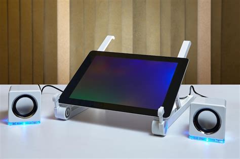 Premium Photo | Digital tablet and speakers on table