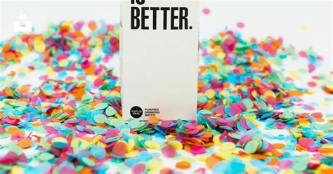 A Boxed Water Carton Sits On Top Of Confetti Photo Free Boxed Water