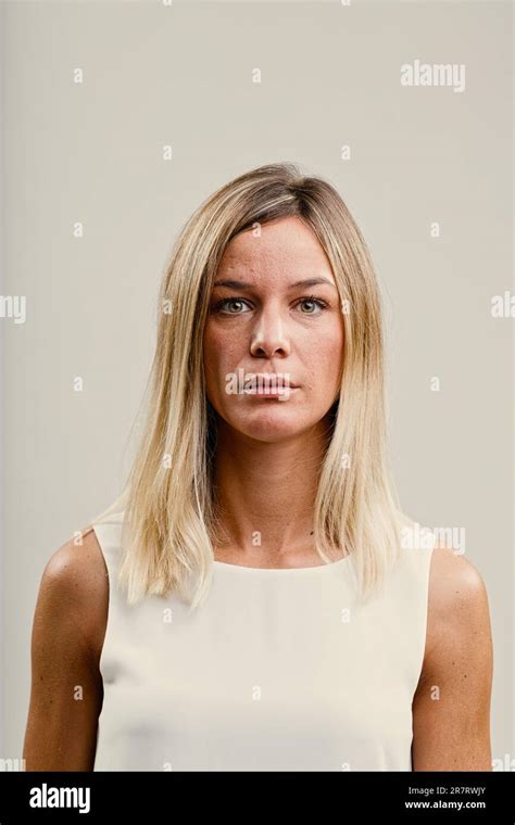 Frontal Portrait Of A Thoughtful Long Haired Blonde Woman Her Serious Demeanor Hides Her Inner