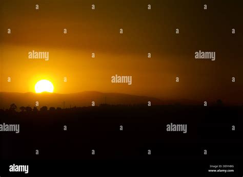 Sunset Over Village Stock Photo Alamy