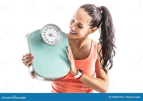 Good Looking Slim Brunette Holds And Oldschool Scale In Her Hands Looking At It And Smiling