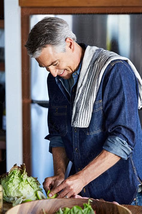 Mature Man Preparing Food In The Kitchen By Stocksy Contributor Trinette Reed Stocksy
