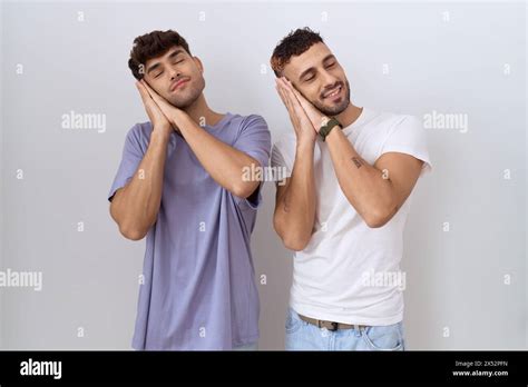 Homosexual Gay Couple Standing Over White Background Sleeping Tired Dreaming And Posing With
