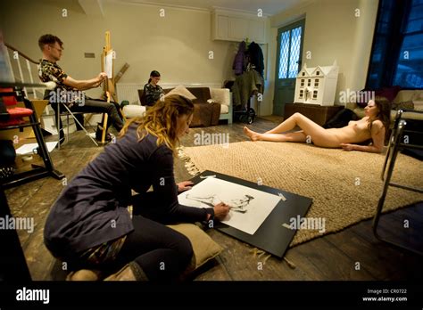 A Naked Woman Poses For A Life Drawing Class Of Artists Stock Photo Alamy