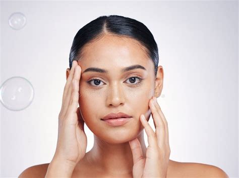 Beauty Skin And Woman With Hands On Face In Studio For Glow