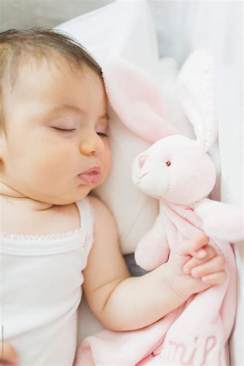 Cute Baby Girl Fast Asleep In The Cradle By Stocksy Contributor