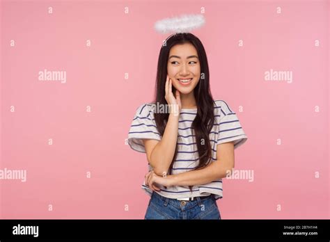 Portrait Of Lovely Angelic Asian Girl With Long Brunette Hair And Halo Over Head Timidly