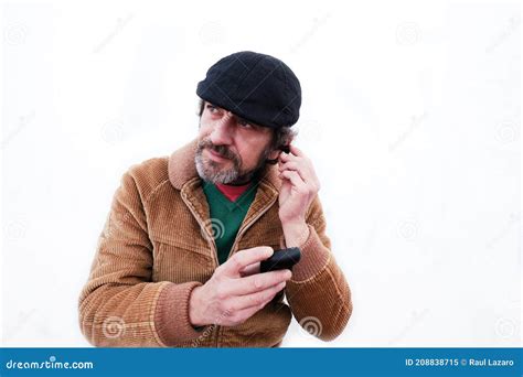 Bearded Man With Cap Putting On Black Wireless Headphones Stock Image