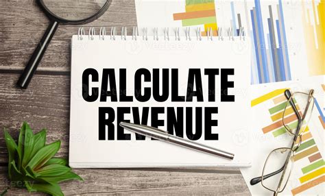 CALCULATE REVENUE On the desktop is a grey notebook, a white sheet of