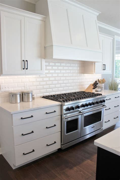 White Cabinet Kitchen With Black Accents And Viking Appliances