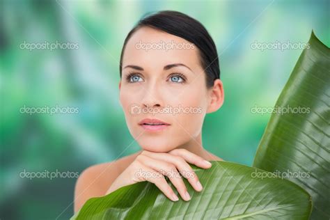 Beautiful Nude Brunette Posing With Green Leaves Stock Photo By Wavebreakmedia 50063485
