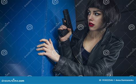 Beautiful Brunette Spy Agent Killer Or Police Woman In Leather Jacket And Jeans With A Gun In