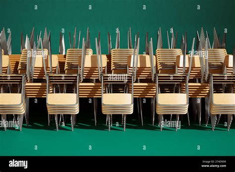 A classroom filled with chairs and tables. Perfect for educational