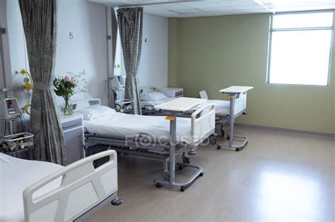 Modern Hospital Ward With Empty Beds Medical Monitor Green Curtains