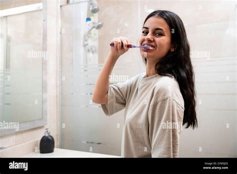BRUNETTE TEEN WITH BRACES BRUSHING HER TEETH Stock Photo Alamy