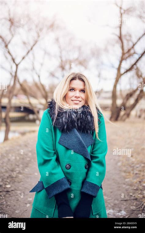 Attractive Blonde In A Beautiful Fashionable Elegant Coat Is Cold From The Cold While Smiling