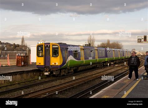Man Waiting For Train At Clapham Junction London Stock Photo Alamy