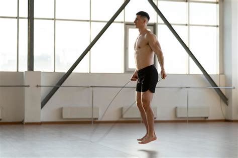 Premium Photo Attractive Hispanic Man With Naked Torso Doing Exercises With Skipping Rope