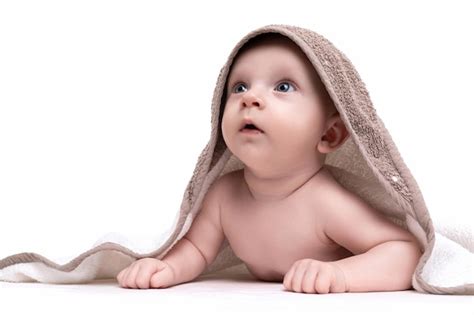 Premium Photo Baby With A Smile On His Face In A Diaper On His Naked Body Laughs Lying On His