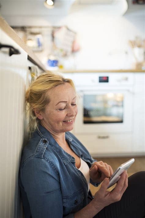 Beautiful Mature Woman At Home Texting With Friends Older Woman Living Alone Enjoying