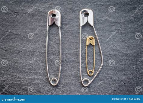 Pregnancy In A Relationship Depicted With Safety Pins Stock Photo