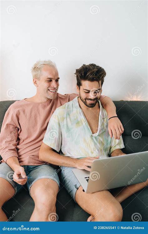 Gay Couple Sitting On Sofa With Laptop Stock Image Image Of Bank Watching 238265541