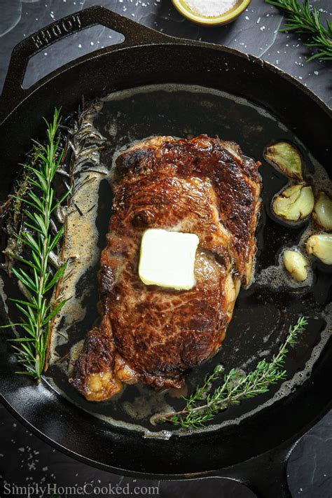 Ribeye Steak In A Cast Iron Pan With Butter Garlic Cloves And