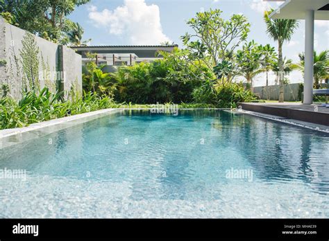Tropical beach resort. Swimming pool near living room Stock Photo - Alamy