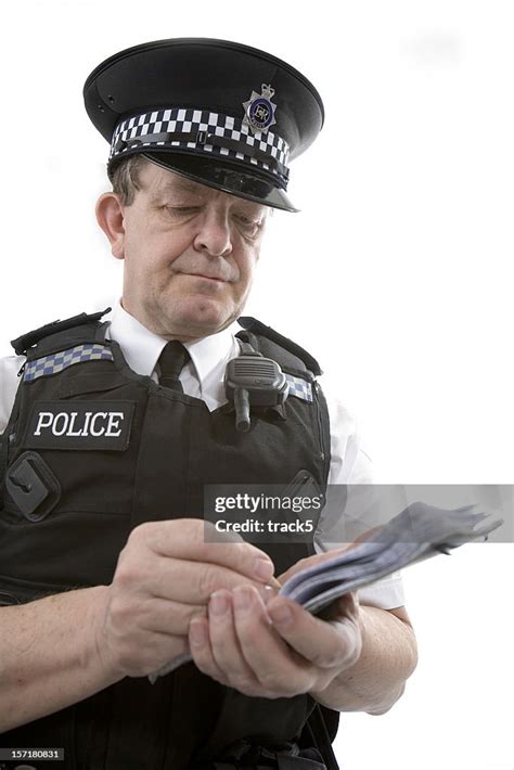 Uk Policeman A Uniformed Officer Taking Notes From A Case High Res