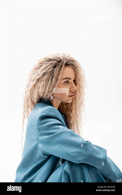 Profile Portrait Of Mesmerizing Woman With Wavy Ash Blonde Hair Wearing Blue Stylish Blazer And