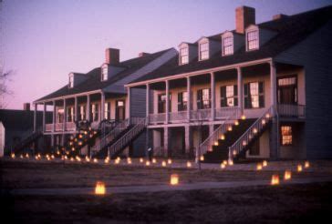 Candles Are Lit In Front Of A Row Of Houses