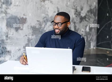 Successful African American Male Employee Using The Laptop For Work At