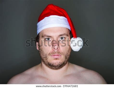 Стоковая фотография Naked Santa Standing Against Black Background Shutterstock