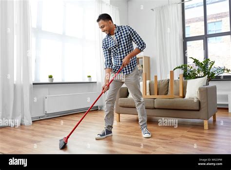 Man Sweeping The Floor