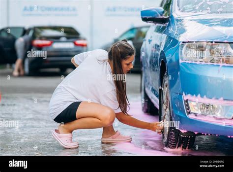 Brunette With Two Pigtails With A Sponge Washes The Rim Stock Photo Alamy