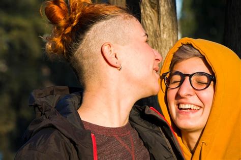 Premium Photo Gay Lesbian Couple Portrait Two Adult Woman In The Park Smiling And Hugging