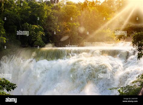 Jungle waterfall cascade in tropical rainforest with sunbeams. El Salto ...