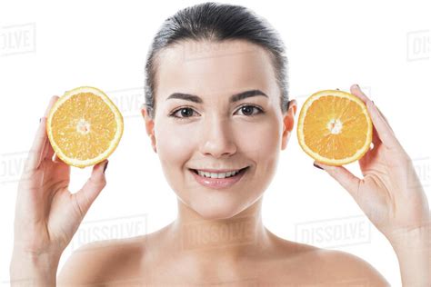 Smiling Attractive Naked Girl With Clean Skin Holding Orange Halves Isolated On White Royalty