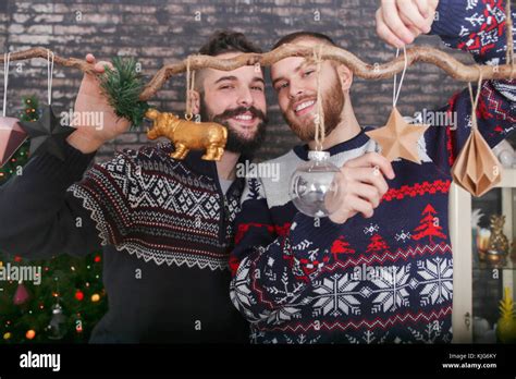Gay Couple Decorating A Branch At Christmas Time Stock Photo Alamy