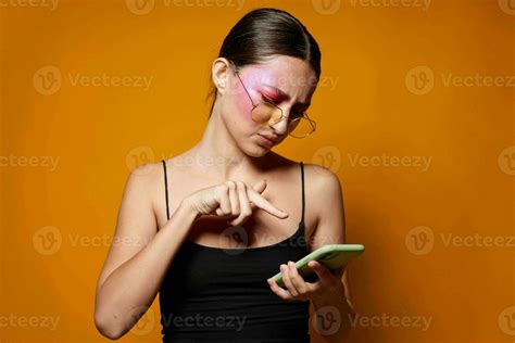 Sexy Brunette Woman With Phone Pink Face Makeup Posing Attractive Look Glasses Yellow Background