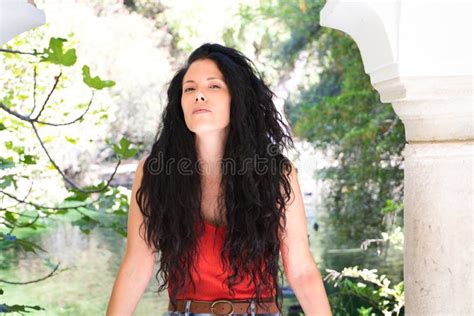 Portrait Of Beautiful Latina Woman Brunette With Curly Hair Is In The Park Making Different