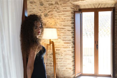 Beautiful Brunette Woman With Curly Hair Leaning On Royal Style Bed Canopy Woman Looks At