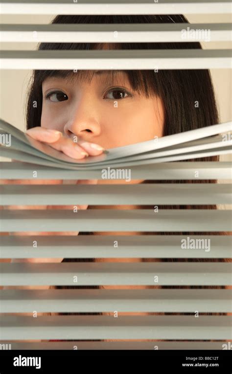 Young Woman Behind Venetian Blinds Stock Photo Alamy