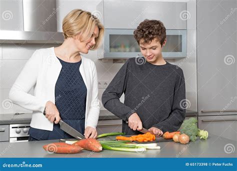 Mother And Son In The Kitchen Stock Photo Image Of Mature Helping
