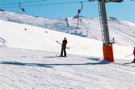 Skier Skiing Downhill In High Mountains Ski Slopes And Ski Lifts