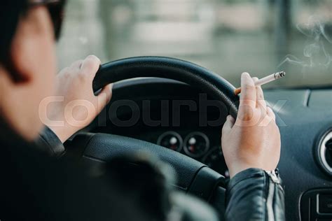 young woman smoking  cigarette  driving  car transportation