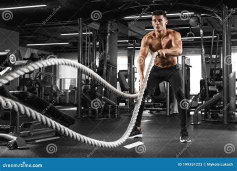 Muscular Man Working Out With Heavy Ropes In Gym Strong Male Naked Torso Abs Stock Image